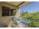 Relaxing balcony with a table and chairs, perfect for enjoying the outdoors at 4201 E Camelback Rd # 74, Phoenix, AZ 85018