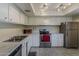 Kitchen featuring white cabinets and stainless steel appliances at 4201 E Camelback Rd # 74, Phoenix, AZ 85018