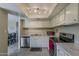 Bright kitchen featuring white cabinets and stainless steel appliances at 4201 E Camelback Rd # 74, Phoenix, AZ 85018