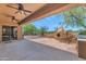 Inviting back patio features a cozy fireplace, built-in grill, and desert landscaping at 42122 N Anthem Springs Rd, Anthem, AZ 85086
