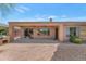 Covered back patio featuring ceiling fans, desert landscaping and an outdoor grill at 42122 N Anthem Springs Rd, Anthem, AZ 85086