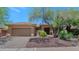 Inviting single-story home featuring xeriscaping with mature trees and a two car garage at 42122 N Anthem Springs Rd, Anthem, AZ 85086