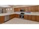 Well-appointed kitchen boasting stainless steel appliances, ample cabinet space, and tiled flooring at 42122 N Anthem Springs Rd, Anthem, AZ 85086