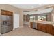 Open-concept kitchen with stainless steel appliances, tile flooring, and a view into the living room at 42122 N Anthem Springs Rd, Anthem, AZ 85086
