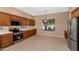 Bright kitchen featuring modern appliances, tile floors, and a sunlit breakfast nook with views of the backyard at 42122 N Anthem Springs Rd, Anthem, AZ 85086