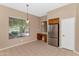 Well lit eat-in kitchen with stainless steel refrigerator, tile floors, and views of the desert landscape at 42122 N Anthem Springs Rd, Anthem, AZ 85086
