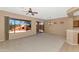 Bright living room features neutral carpet, backyard views, and sliding door access at 42122 N Anthem Springs Rd, Anthem, AZ 85086