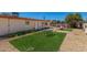 Large backyard featuring artificial turf, gravel, and a privacy fence at 4501 N 60Th Ave, Phoenix, AZ 85033