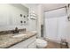Cozy bathroom featuring granite countertops, a shower with curtain, and toilet at 4501 N 60Th Ave, Phoenix, AZ 85033