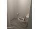 Modest bathroom featuring a standard toilet and gray wood-look tile flooring at 4501 N 60Th Ave, Phoenix, AZ 85033