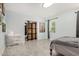 Neutral bedroom with tile flooring, a window, and a cozy bed at 4501 N 60Th Ave, Phoenix, AZ 85033