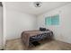 Small, sparse bedroom featuring tile flooring, a window, and a bed at 4501 N 60Th Ave, Phoenix, AZ 85033