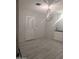 Dining room features wood-look tile, modern chandelier and bright white walls at 4501 N 60Th Ave, Phoenix, AZ 85033