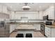 Traditional kitchen features granite countertops, stainless steel appliances, and white cabinetry at 4501 N 60Th Ave, Phoenix, AZ 85033