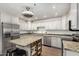 Updated kitchen with modern appliances, granite countertops, white cabinetry, and an island with bar seating at 4501 N 60Th Ave, Phoenix, AZ 85033
