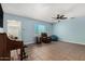 Relaxing living room features a piano, ceiling fan, and a comfortable recliner at 4501 N 60Th Ave, Phoenix, AZ 85033