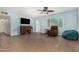 Spacious living room features a piano, ceiling fan, recliner, and a unique patterned window at 4501 N 60Th Ave, Phoenix, AZ 85033