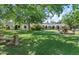 Lush backyard with a decorative fountain, bench seating, and classic architecture under a canopy of trees at 5225 N 23Rd St, Phoenix, AZ 85016