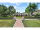 Beautifully landscaped backyard with a brick walkway, manicured hedges, and classic architecture at 5225 N 23Rd St, Phoenix, AZ 85016