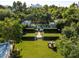 Expansive backyard with a lush lawn, mature trees, pool, and manicured landscaping, creating a private oasis at 5225 N 23Rd St, Phoenix, AZ 85016