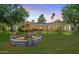 Serene backyard featuring a decorative fountain, manicured lawn, and classic architecture at sunset at 5225 N 23Rd St, Phoenix, AZ 85016