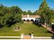Expansive backyard featuring a large lawn, mature trees, a charming water fountain, and a covered patio at 5225 N 23Rd St, Phoenix, AZ 85016