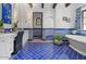 Elegant bathroom with unique blue tile flooring and wall accents, paired with a white vanity at 5225 N 23Rd St, Phoenix, AZ 85016