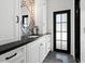 Stylish bathroom with white cabinets, black countertop, and eye-catching patterned wallpaper above the sink at 5225 N 23Rd St, Phoenix, AZ 85016