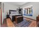 Charming bedroom featuring a window seat, hardwood floors, and blue accents at 5225 N 23Rd St, Phoenix, AZ 85016