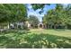 Charming home with a lush green lawn and mature trees creating a serene and inviting atmosphere at 5225 N 23Rd St, Phoenix, AZ 85016
