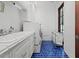 Well-lit laundry room featuring blue tile flooring and stacked washer and dryer for convenient home management at 5225 N 23Rd St, Phoenix, AZ 85016