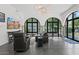 Bright living room features arched windows, stone columns, recessed lighting and sleek concrete floors at 5225 N 23Rd St, Phoenix, AZ 85016
