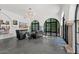 Bright living room boasts recessed lighting, arched windows, stone columns, and sleek concrete floors at 5225 N 23Rd St, Phoenix, AZ 85016