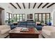 Inviting living room with beamed ceilings, a cozy sofa, and expansive windows overlooking the lush yard at 5225 N 23Rd St, Phoenix, AZ 85016