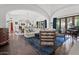 Spacious living room featuring vaulted ceilings, hardwood floors, stylish furniture, and an abundance of natural light at 5225 N 23Rd St, Phoenix, AZ 85016
