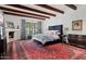 Serene main bedroom with beamed ceilings, a decorative fireplace, and natural light at 5225 N 23Rd St, Phoenix, AZ 85016