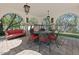 Charming outdoor dining area with shade, stone floors, columns, lighting and ornate wrought iron table and chairs at 5225 N 23Rd St, Phoenix, AZ 85016