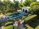 A pool area with mature plants, a large pool, and a white structure at 5225 N 23Rd St, Phoenix, AZ 85016