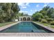 Backyard pool featuring a textured pool bottom, brick trim, and a covered pool house in lushly landscaped surrounds at 5225 N 23Rd St, Phoenix, AZ 85016