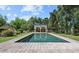 Sparkling pool with stone trim reflects adjacent lounge area in a meticulously landscaped backyard retreat at 5225 N 23Rd St, Phoenix, AZ 85016