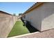 Artificial turf in the backyard alongside the home's exterior and rock landscaping at 5437 W Bluefield Ave, Glendale, AZ 85308