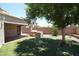 Inviting backyard oasis with a built-in BBQ, artificial turf, and a covered patio area at 5437 W Bluefield Ave, Glendale, AZ 85308