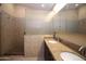 Bathroom featuring dual vanity with granite counters, tile shower with glass door, and tile flooring at 5437 W Bluefield Ave, Glendale, AZ 85308