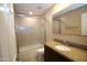 Bathroom featuring single vanity, granite counters, and shower with glass doors at 5437 W Bluefield Ave, Glendale, AZ 85308