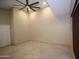 Bedroom featuring tray ceiling with fan, neutral walls, and neutral tile flooring at 5437 W Bluefield Ave, Glendale, AZ 85308
