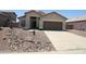 Charming single-story home with a desert landscape, neutral stucco, and a two-car garage at 5437 W Bluefield Ave, Glendale, AZ 85308