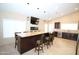 Spacious kitchen featuring stainless steel appliances, granite countertops and an island with seating at 5437 W Bluefield Ave, Glendale, AZ 85308