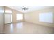Bright living room featuring tile floors, neutral paint, and a ceiling fan at 5437 W Bluefield Ave, Glendale, AZ 85308