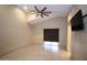 Main bedroom featuring ceiling fan, sliding glass door, and neutral tile flooring at 5437 W Bluefield Ave, Glendale, AZ 85308