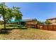 A spacious backyard featuring a lush lawn, wooden deck with an above ground pool, perfect for outdoor entertainment at 557 S Lemon Ct, Gilbert, AZ 85296